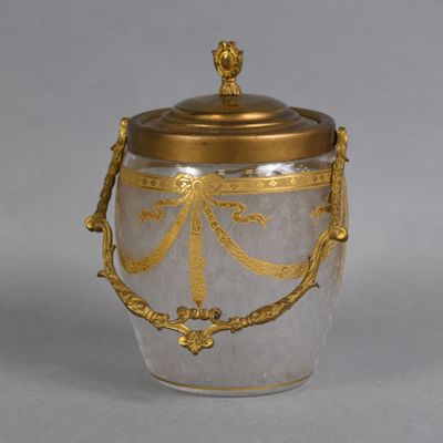 a silver and gold vase with a gold lid