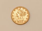 a close up of a gold coin on a white surface