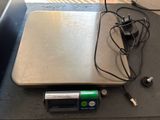 a scale that is sitting on a table with a charger on it