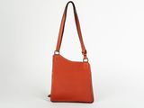 an orange handbag on a white background