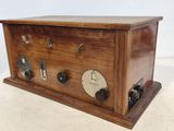 a wooden box with a clock on it on a table