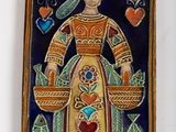 a picture of a decorative plaque with a woman holding a heart