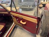 a car that is parked in a garage with its door open