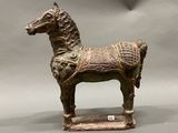 a statue of a horse with a saddle on it ' s back