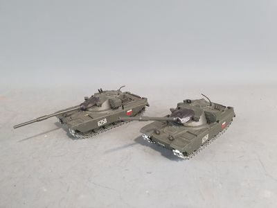 two toy tanks sitting side by side on a white surface