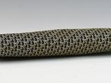 an image of a close up of a roll of fabric on a white surface