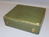 a small green box sitting on a white table
