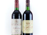 two bottles of wine sitting next to each other on a white surface