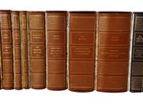 books are lined up in a row on a white surface