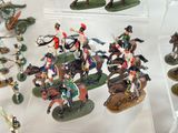 many figurines of soldiers on display in a display case