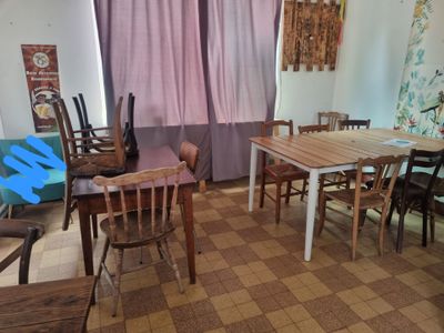 a room with a table, chairs, and a guitar in it