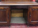 a wooden desk with a mirror on top of it