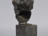 a bronze bust of a man with a beard on a marble base