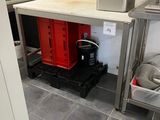 a small kitchen with a refrigerator, sink, and other appliances
