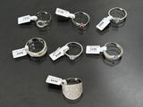 several different types of rings with price tags on them on a table