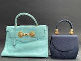 two small purses with handles and handles on a gray background