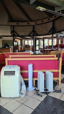 a room with a lot of appliances and a table