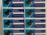 a stack of four boxes of fluocant cartridges on a white surface