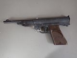 a gun that is on the table next to a knife