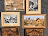 quatre photos encadrées représentant des montagnes et des maisons, exposées dans une pièce