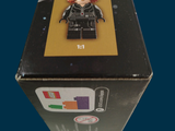 a box with a lego figure in it on a table