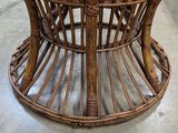 a wicker table with a glass top on the floor
