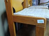 a wooden chair that is sitting on a wooden table