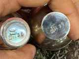 a person that is holding a silver object in their hand