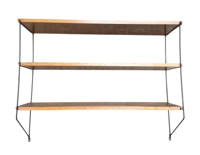 the three tiered shelf is made of wood and metal