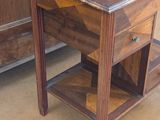 a small wooden table with a drawer on top of it