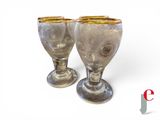 two wine glasses sitting next to each other on a table