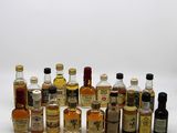 many bottles of alcohol that are lined up on the table