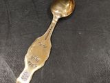 a spoon that is sitting on a black cloth