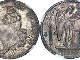 a silver coin with an image of a man on it