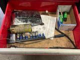 a red tool box with a lot of tools inside of it