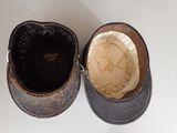 two hats that are sitting side by side on a table