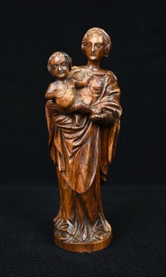 a wooden statue of a woman holding a child