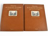 two books on a white surface one is brown and the other is black