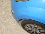 a blue car that is parked on the side of the road
