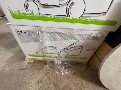 une caisse sur laquelle est posée une tondeuse à gazon