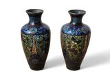two vases sitting side by side on a white surface