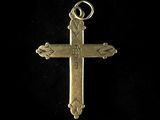 a gold cross pendant with a cross on it ' s side