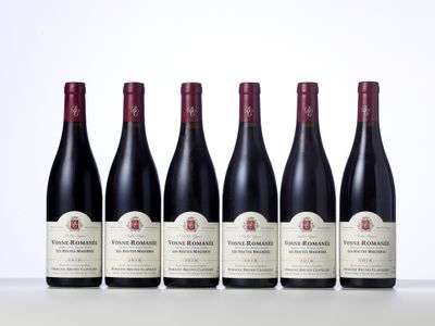 six bottles of red wine lined up in a row