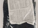a bag of black cloth on a white surface