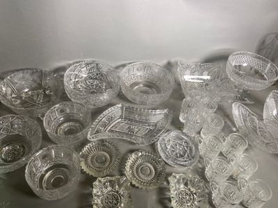 a lot of glass dishes and bowls on the table