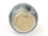 a close up of a blue and white vase on a white surface