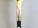 a statue of jesus on a cross on a pedestal
