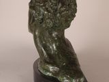 bronze sculpture of a lion head on a black base