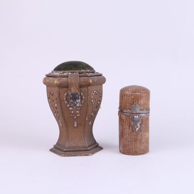 a small wooden container with a green plant in it