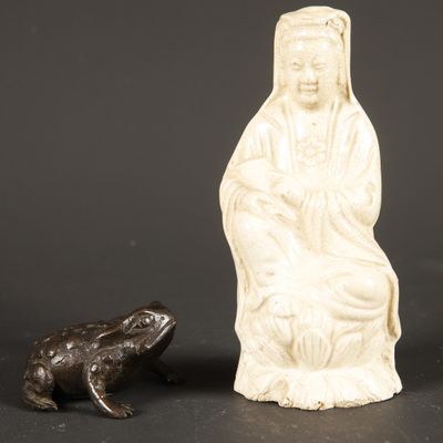 a statue of a woman and a frog sitting next to each other